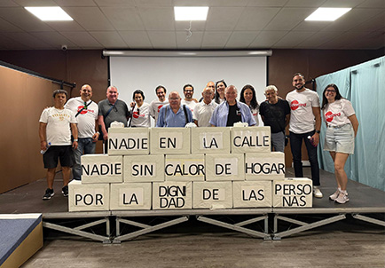 Grupo de voluntarios de Edenred en evento Ideal Day con carteles contra pobreza