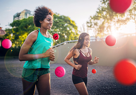 Dos mujeres corriendo juntas en parque al atardecer
