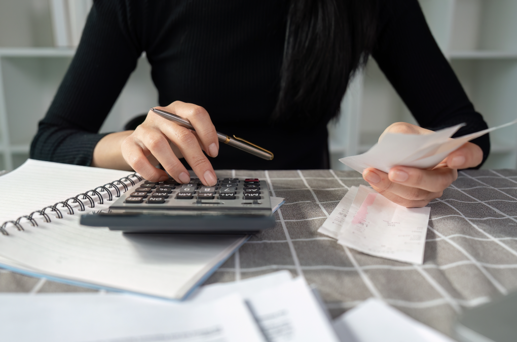 a person doing calculations with a calculator